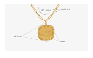Detailed close-up of a gold square pendant necklace with intricate French engraving