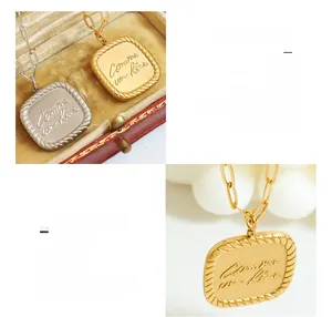 Detailed close-up of 18K gold plated titanium steel square pendant with queen engraving