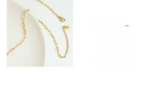 Close-up of 18K gold plated paperclip chain with lobster clasp and K18 tag