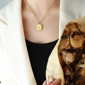 Elegant 18K gold plated titanium necklace with vintage square letter pendant on a model
