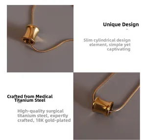 Macro detail of 18K gold plated titanium steel waist cylinder pendant on snake chain