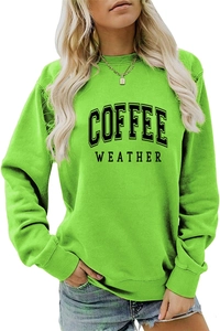 Close-up detail of COFFEE WEATHER print and ribbed cuffs on green crewneck sweatshirt