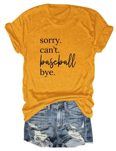 Flat lay of women's mustard t-shirt with 'sorry can't' print and ripped denim shorts
