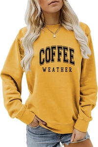 Close-up of ginger yellow crewneck sweatshirt with black Coffee Weather print detail