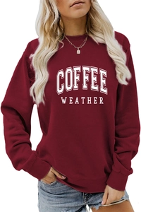 Detailed close-up of ribbed crewneck and COFFEE WEATHER print on burgundy sweatshirt