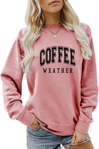 Detail of pink crewneck sweatshirt featuring black Coffee Weather graphic print