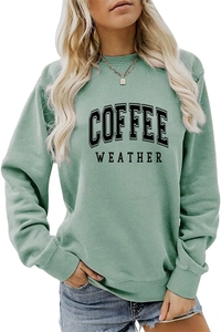 Close-up of sage green sweatshirt with COFFEE WEATHER print and ribbed knit cuffs