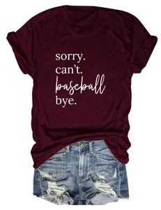 Flat lay of burgundy t-shirt with Sorry Can't Baseball print and ripped denim shorts