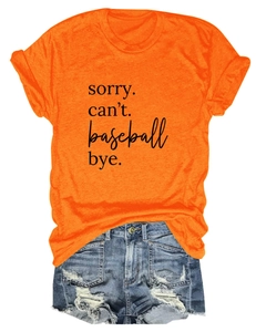 Flat lay of an orange cotton t-shirt with sorry can't baseball bye print and denim shorts