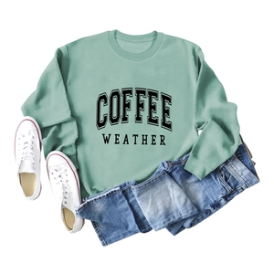 Flat lay of light green crewneck sweatshirt with black COFFEE WEATHER graphic print