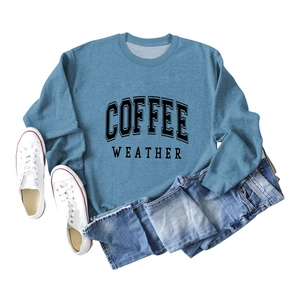 Close-up of Coffee Weather print on blue crewneck sweatshirt with ribbed cuffs