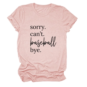 Close-up of pink crew neck tee with sorry can't baseball bye text and rolled sleeves
