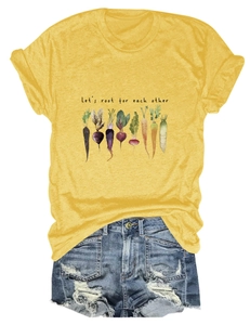 Flat lay of yellow t-shirt with vegetable illustration and distressed denim shorts