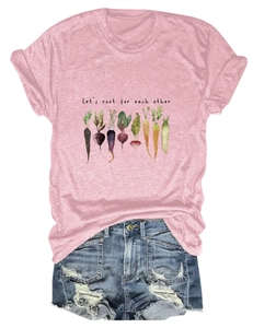 Flat lay of pink watercolor vegetable tee and distressed denim shorts with frayed edges