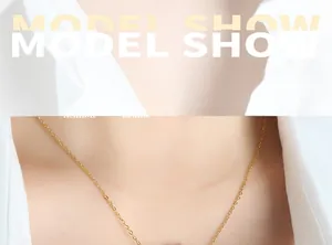 Close-up of a gold-plated knotted geometric pendant necklace on a white shirt