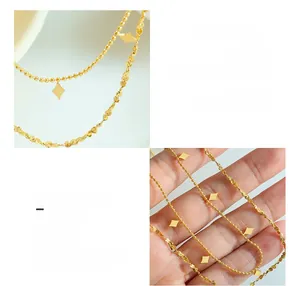 Detail of 18K gold plated titanium double layer necklace with geometric rhombus charms
