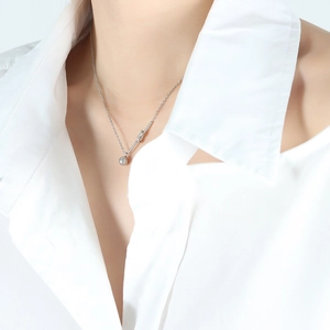 Minimalist silver geometric knot necklace with a polished steel ball on a delicate chain