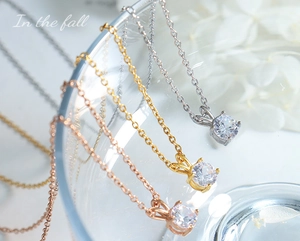 Detailed shot of single zircon pendant necklaces in rose gold, gold and silver finishes