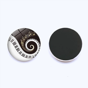Detail of round heart piano key fridge magnet with musical notes and magnetic back