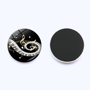 Detail view of heart piano keys fridge magnet with musical notes on glass surface