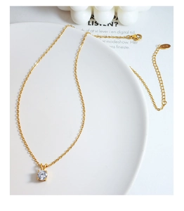 Detailed macro view of 18K gold plated titanium necklace with K18 engraved metal tag