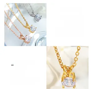 Detailed macro of 18K gold plated titanium necklaces featuring claw-set cubic zirconia