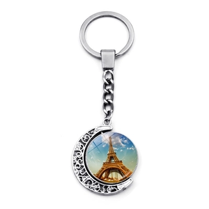 Detail of Eiffel Tower glass pendant keychain with silver-colored crescent moon metal frame