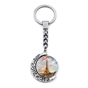 Rotating silver Eiffel Tower keychain with crescent moon and glass gem pendant