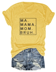 Flat lay of yellow Mama Mom Bruh graphic T-shirt paired with distressed denim shorts