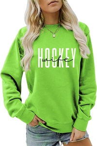 Detail of neon green crewneck sweatshirt with white HOCKEY wife graphic print and fabric texture