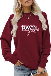 Detail of burgundy sweatshirt with white just a small town girl slogan print