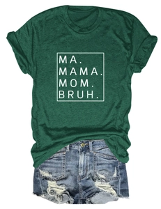 Close-up of deep green t-shirt with MA MAMA MOM BRUH white text print and denim shorts