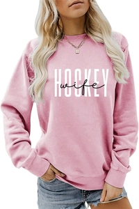 Detailed view of pink long sleeve sweatshirt with white HOCKEY wife graphic print