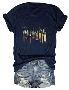 Flat lay of navy t-shirt with Let's Root For Each Other vegetable print and denim shorts