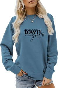 Detail of greyish blue crewneck sweatshirt with just a small town girl graphic text