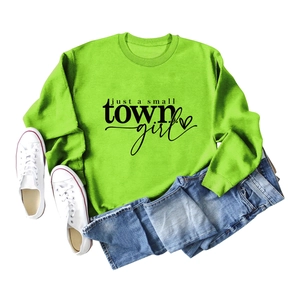 Flat lay of neon green sweatshirt with just a small town girl print and denim jeans