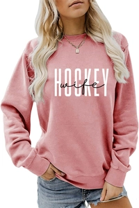 Close-up of white Hockey Wife text print on vintage pink long sleeve sweatshirt