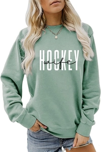 Close-up of the Hockey Wife print on a sage green round neck sweatshirt for women