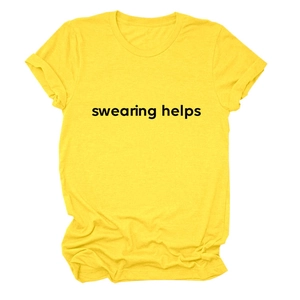 Detail of loose yellow cotton T-shirt featuring bold black Swearing Helps print text