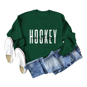 Flat lay of a dark green crewneck sweatshirt featuring HOCKEY wife print with casual denim