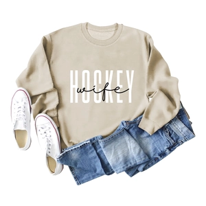 Flat lay of khaki long sleeve hockey wife sweatshirt with blue jeans and canvas shoes