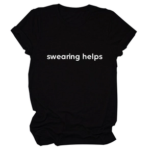 Close-up of 'swearing helps' white typography on a premium black cotton crew neck t-shirt