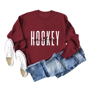 Detailed flat lay of burgundy sweatshirt with white HOCKEY wife graphic and ribbing