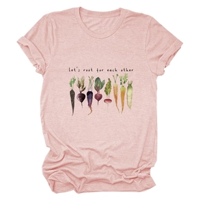 Detailed flat lay of pink cotton T-shirt featuring vegetable graphics and inspirational text