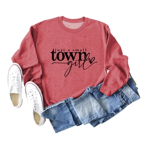 Flat lay of vintage red sweatshirt with 'just a small town girl' print and heart detail