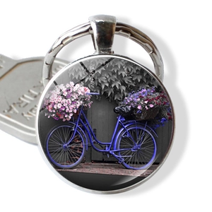Vintage silver keychain with glass cabochon featuring a blue bicycle and purple flowers