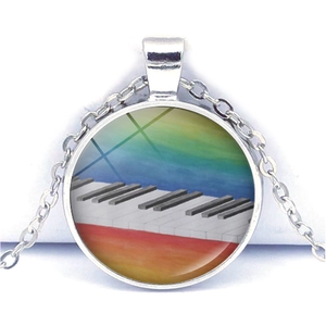 Close-up of heart-shaped piano keys pendant with a rainbow glass dome and silver chain
