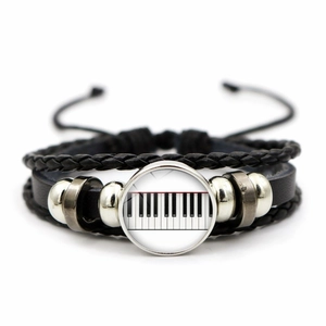 Detail of multi-layer leather bracelet with piano keys glass gem and braided cords