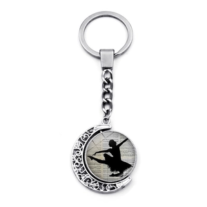 Detailed view of ballet dancer silhouette keychain with moon bracket and musical notes