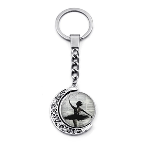 Detailed silver crescent moon keychain featuring a ballerina silhouette and musical notes